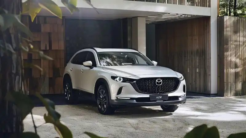 A photo of the 2024 Mazda CX-90 parked in a modern urban setting.