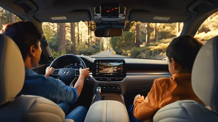 A family enjoying the advanced technology in a Hyundai Palisade.